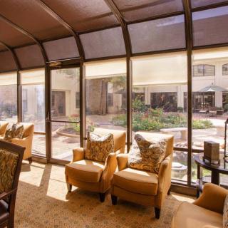 A cozy lounge area with plush chairs and large windows allowing natural light to fill the space.