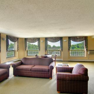 A spacious living room with comfortable seating and large windows allowing natural light to fill the space.