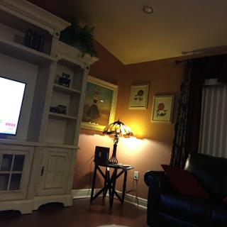 A cozy living room setting with warm lighting and comfortable furniture.