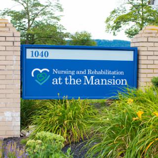 Sign for Nursing and Rehabilitation at the Mansion, indicating the facility's location and services.
