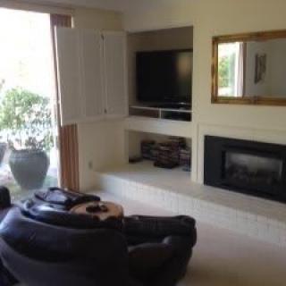 A cozy living room with a fireplace, TV, and comfortable seating.