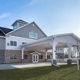 A modern residential building with a covered entrance and well-maintained exterior.
