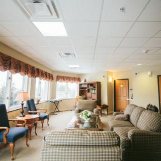Cozy lounge area with comfortable seating and large windows.