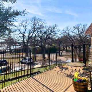A peaceful outdoor patio overlooking a scenic view of trees and a clear blue sky.