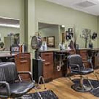 A modern hair salon interior with styling chairs and professional equipment.