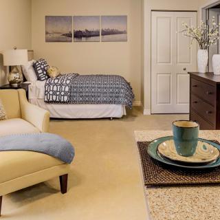 A cozy bedroom with a bed, sofa, and stylish decor.