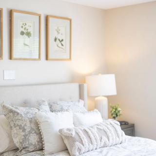 A cozy bedroom with stylish decor and ample natural light.