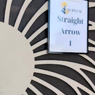 A decorative sign labeled 'Straight Arrow 1' set against a stylized sun-like background.