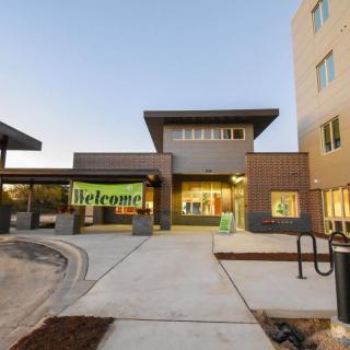 A modern commercial building with an inviting entrance at dusk.
