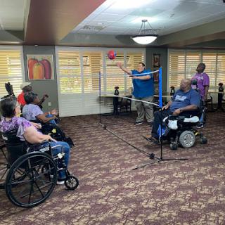 Residents engaged in a fun indoor activity, promoting social interaction and physical exercise.