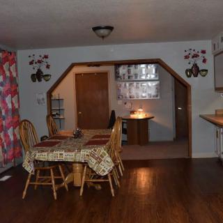 A cozy dining area with wooden furniture and decorative wall accents.