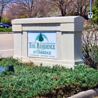 Entrance sign for The Reserve at Glenridge, located near a road surrounded by greenery.