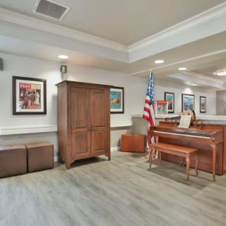 A courtroom with wooden furniture and an American flag.