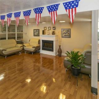 A cozy living room decorated with American flag banners and modern furniture.