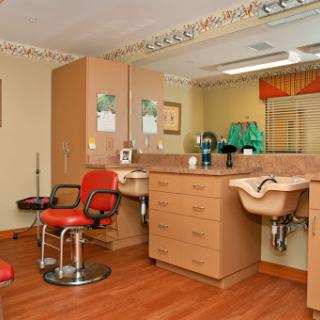 A well-organized salon space featuring styling chairs and workstations.