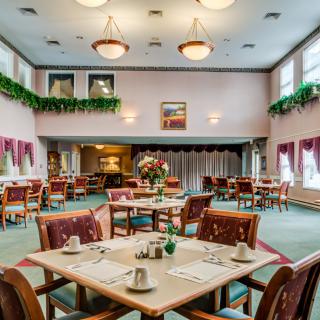 A spacious dining room with neatly arranged tables and elegant decor.