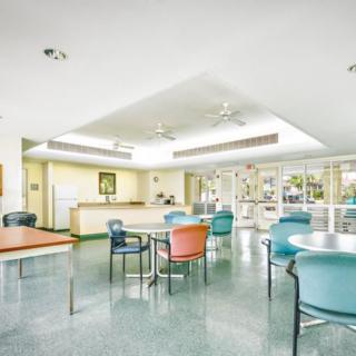 A brightly lit waiting room with colorful chairs and tables.