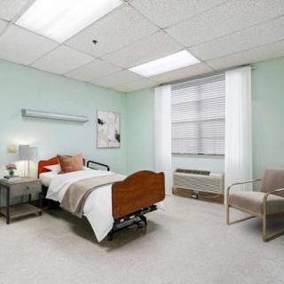 A clean and minimalistic hospital room with a single bed, chair, and soft lighting.