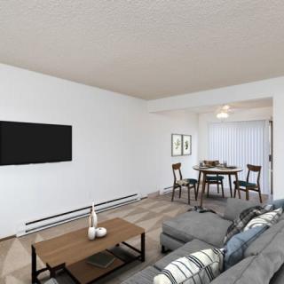 A modern, minimalist living room with a dining area in the background.