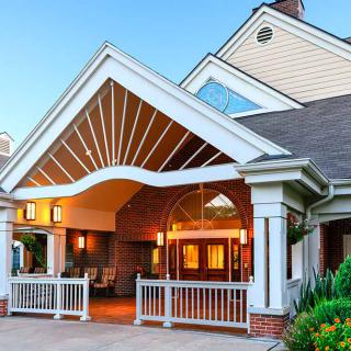 Front entrance of a residential building with a peaked roof and welcoming porch.