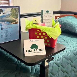 A welcoming setup in a cozy bedroom, featuring an information display and a basket of amenities.