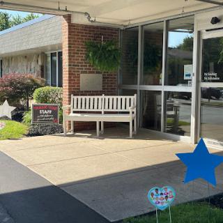 A welcoming entrance with a bench and decorative elements.