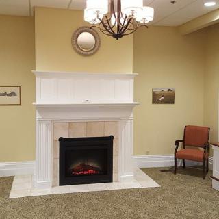 A cozy living room with a white fireplace and elegant decor.