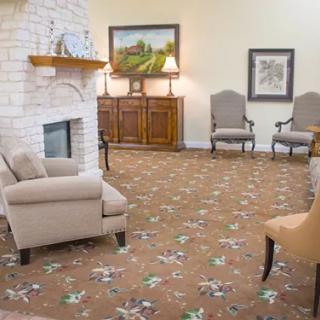 A cozy living room featuring comfortable seating, a fireplace, and elegant decor.