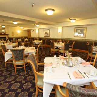 An empty restaurant dining area with neatly arranged tables and chairs.