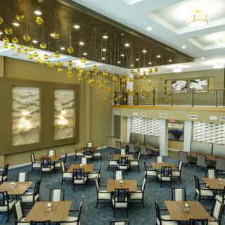 A spacious and modern dining hall with elegant interior design and contemporary lighting.