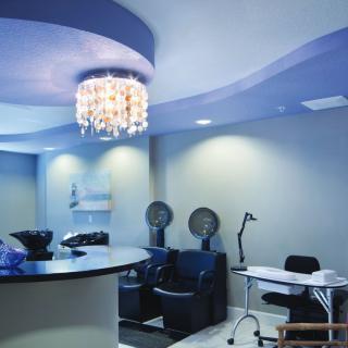 A modern hair salon featuring stylish lighting and sleek furniture.