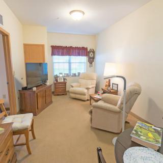 A cozy living room with comfortable armchairs and a TV.