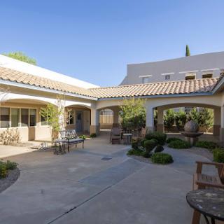 A serene courtyard featuring a blend of architectural elements and well-maintained landscaping, perfect for relaxation.