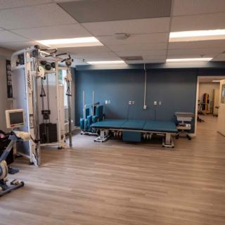 A clean and organized gym space with exercise equipment.