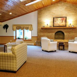 A cozy lounge area with comfortable seating and a fireplace.