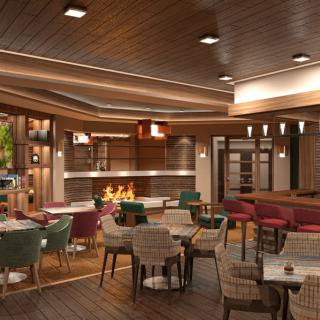A modern restaurant interior with a cozy atmosphere, featuring a fireplace and colorful seating.