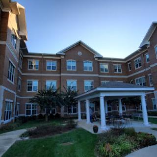 A modern residential building featuring a well-maintained exterior and landscaped garden.