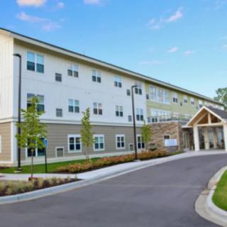 A modern residential building with well-maintained landscaping and a welcoming entrance.