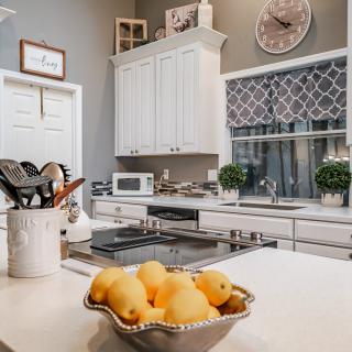 A cozy kitchen interior with a bowl of lemons on the countertop.