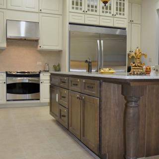 A modern kitchen with a large island and stainless steel appliances.