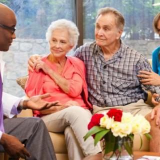 A group of people having a friendly discussion in a cozy indoor setting.