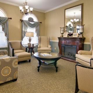 A traditionally styled living room featuring a fireplace and elegant seating arrangement.