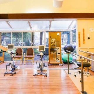 A rehabilitation facility with various fitness equipment for physical therapy.