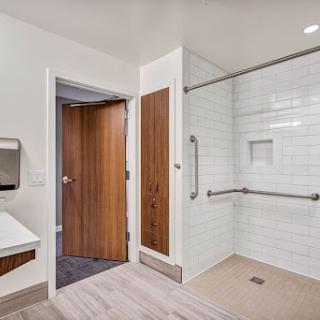 A modern, accessible bathroom featuring a spacious shower area and contemporary fixtures.