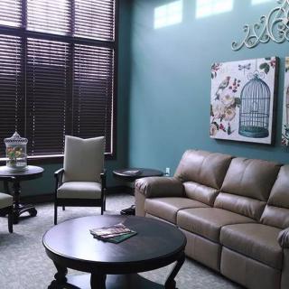 A cozy living room with comfortable seating and decorative wall art.