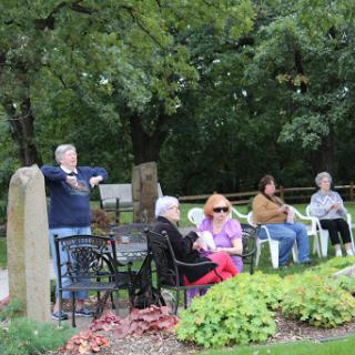 A group of seniors enjoying a leisurely moment in the park, surrounded by nature.