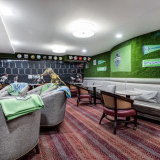 A cozy lounge area with cushioned seating and vibrant green decor.