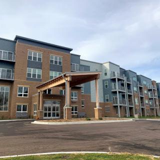 A modern residential apartment building featuring a welcoming entrance.