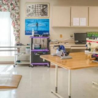 A physical therapy room equipped with exercise and rehabilitation tools.