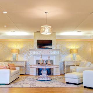 A modern living room with elegant furniture and a cozy fireplace.